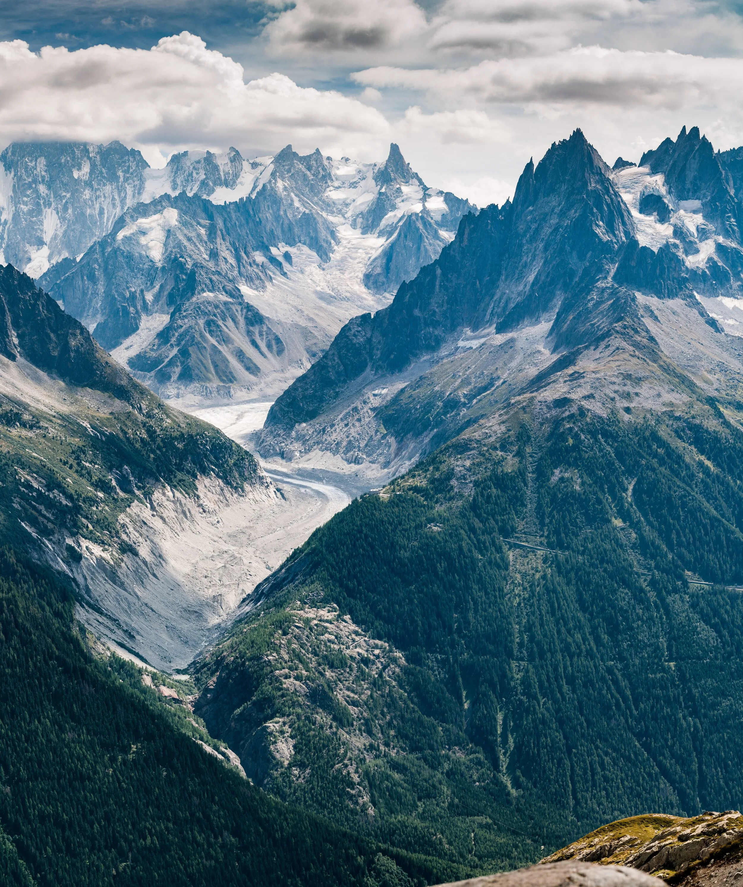 Snow-covered mountain ridges rising through clouds